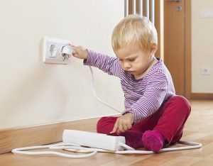 Baby playing with electrical extension